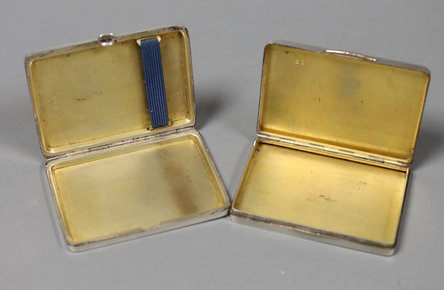An Art Deco engine turned silver cigarette case, Crisford & Norris, Birmingham, 1934, 81mm and one other silver case.